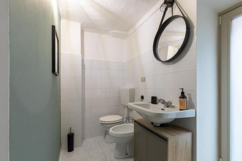 a bathroom with a sink and a toilet and a mirror at Beer and Dream in Cuneo