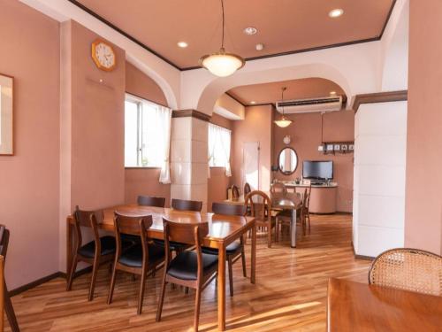 a dining room with a table and chairs at Tabist Hotel Sankoen in Hitachi
