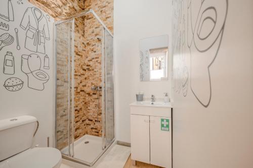 a bathroom with a shower and a toilet at SÃO VICTOR Studios HISTORIC CENTER in Braga