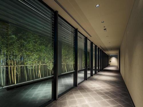 a row of windows in a building with trees outside at HOTEL CLAD in Fuji