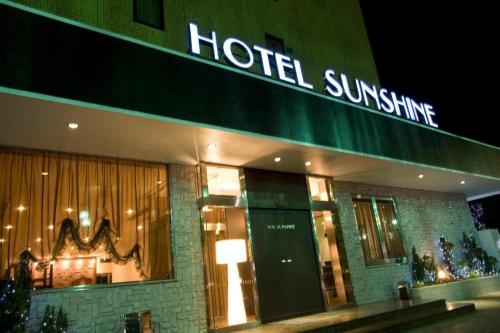 a hotel with a sign that reads hotel sunshine at Tabist Sunshine Koga in Koga