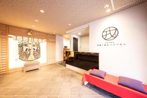 a waiting room with a couch in the middle of a building at NAMBA EBISU HOTEL in Osaka