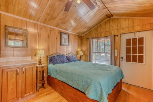 a bedroom with a bed and a wooden ceiling at Enchanted Hideaway Cabins and Cottages in Ruidoso
