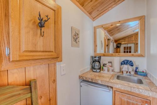 a kitchen with a sink and a counter at Enchanted Hideaway Cabins and Cottages in Ruidoso