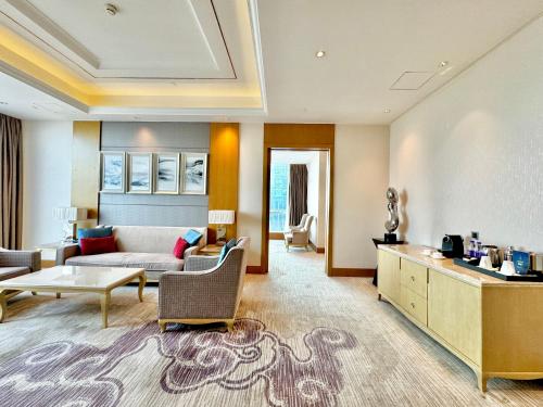 a living room with a couch and a table at DoubleTree by Hilton Guangzhou - Canton Fair Free Shuttle Bus & Exhibition Registration Service in Guangzhou