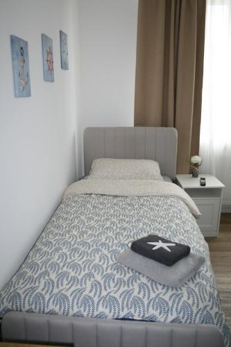 a bed with a blue and white comforter on it at Seehafen Hostel in Hamburg