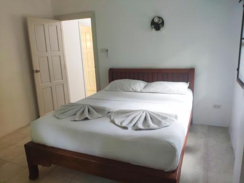 a bed with white sheets and pillows in a bedroom at Samui Green Life in Bophut 