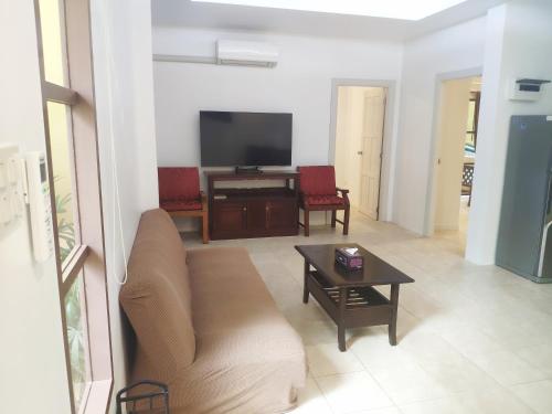 a living room with a couch and a table at Samui Green Life in Bophut 