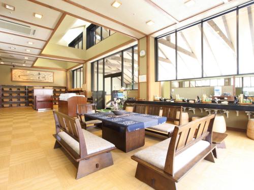 a restaurant with a table and chairs and windows at Yuzanso in Otsu