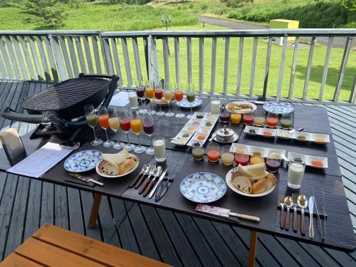 a picnic table with food and drinks on a deck at GRAND VERDE RESORT in Kamegawa