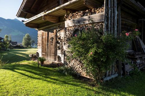 a stone building with a bush on the side of it at Chalet 104 Westendorf by ALPS RESORTS in Westendorf