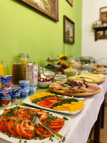 a table with many plates of food on it at Gościniec Kowalova in Mieroszów