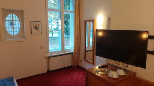 a living room with a large flat screen tv at die Villa, Zimmer 17, DZ in Leverkusen