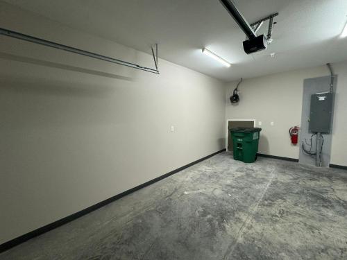 an empty room with a green trash can in it at NDSU Close #103 Relax and enjoy Fargo! in Fargo