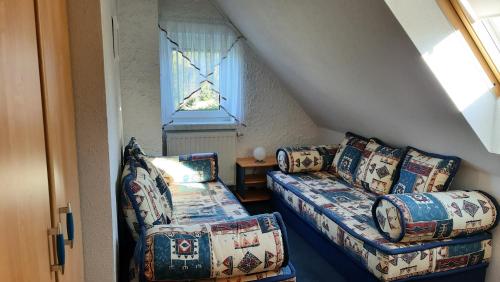 a living room with two couches and a window at Ferienwohnung Renner in Kurort Altenberg