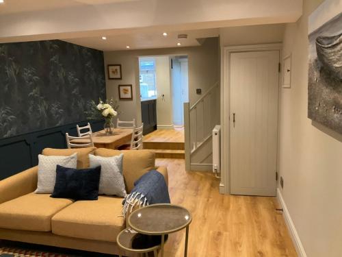 a living room with a couch and a table at Fab cottage in the heart of Deal - Great Location in Kent