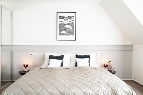a bedroom with a large bed with two tables at Prague City Golf Apartments in Prague