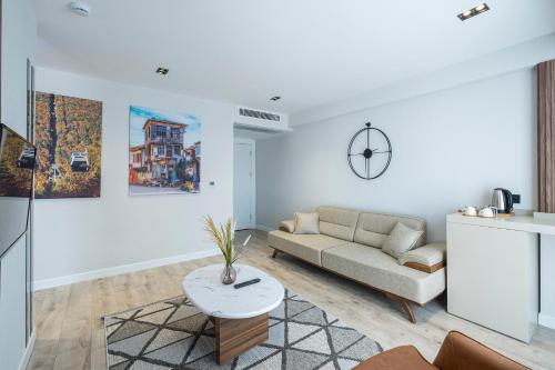 a living room with a couch and a table at Euphrates Hotel Bursa in İhsaniye