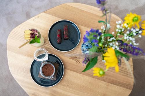 a table with plates of food and flowers on it at Prague City Golf Apartments in Prague