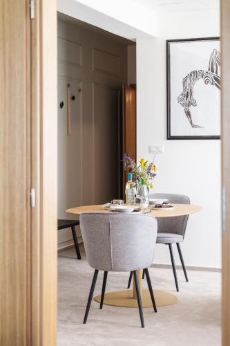 a dining room with a table and chairs at Prague City Golf Apartments in Prague