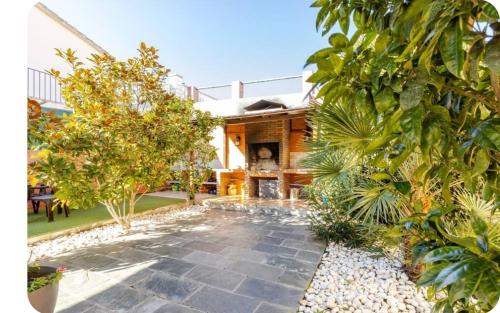 a garden with a stone walkway in front of a house at Raco de Lis in La Torre de Claramunt