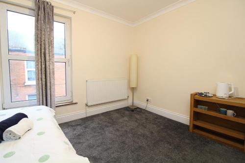 a bedroom with a bed and a window and a chalkboard at Centrally located double room in Southampton