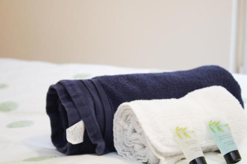 a pile of towels sitting on top of a bed at Centrally located double room in Southampton