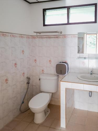 a bathroom with a toilet and a sink at Burni Houses in Klong Prao Beach