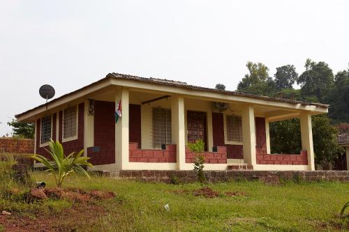 a house with a flag on the front of it at Bramhagiri Resort in Lānja