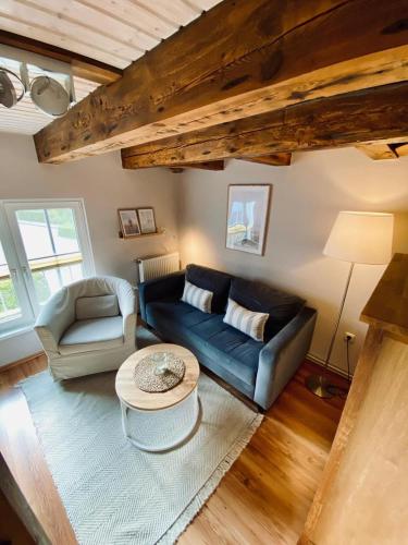 a living room with a blue couch and a table at Trafohaus in Zingst
