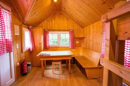 a wooden room with a wooden table in a cabin at Eifel-Camp Freilinger See in Freilingen