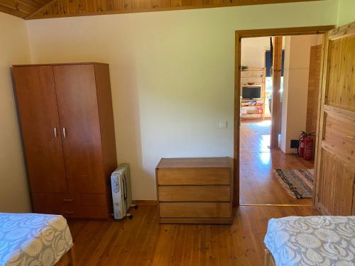 a room with two beds and a dresser and a bedroom at Kasteheina kodu in Voka