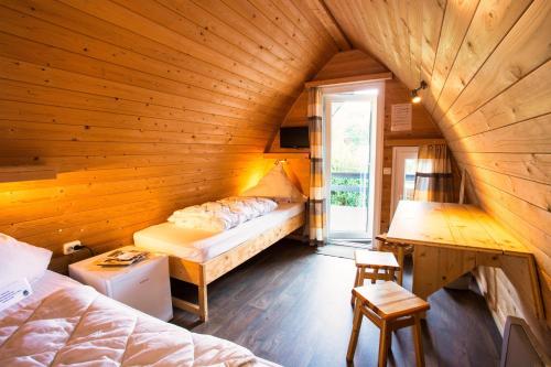 a room with two beds in a wooden room at Eifel-Camp Freilinger See in Freilingen