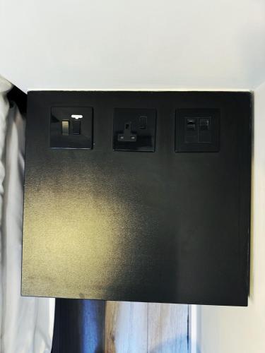 a close up of a black electrical box with at 95 Studios in London