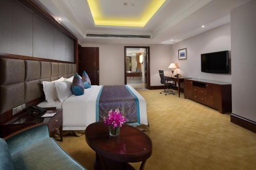 a hotel room with a bed and a couch at Crowne Plaza Deqing Moganshan by IHG in Deqing