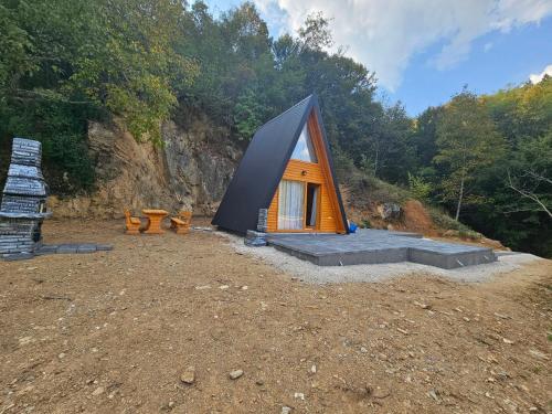 a small tent on a hill with trees in the background at Kucica na kraju KNK in Zvornik