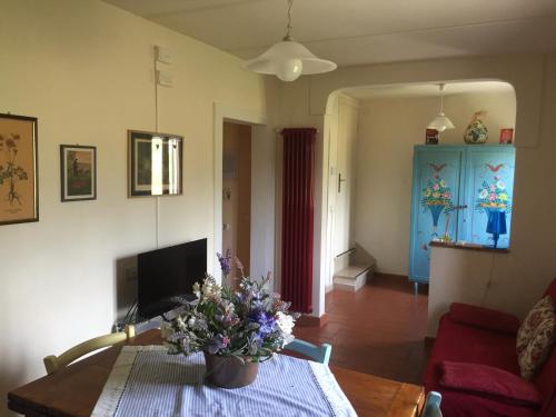 a living room with a table with flowers on it at Al Vecchio Leccio in Pistoia