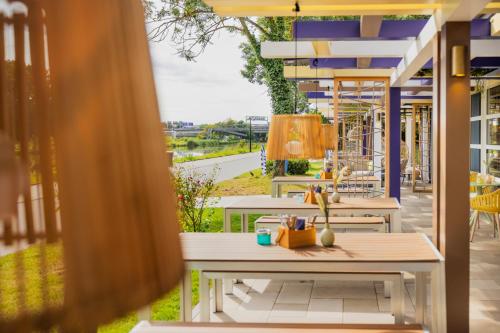 a view of a patio with tables and chairs at Ibis Styles Regensburg in Regensburg
