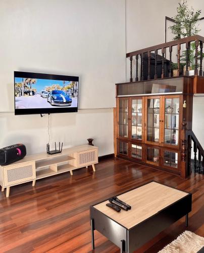 a living room with a flat screen tv on a wall at 97 Light House Songkhla in Songkhla