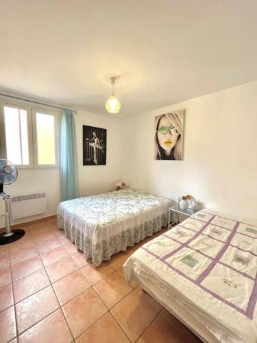 une chambre avec deux lits dans une pièce dans l'établissement Appartement vue mer avec piscine, à LʼÎle-Rousse