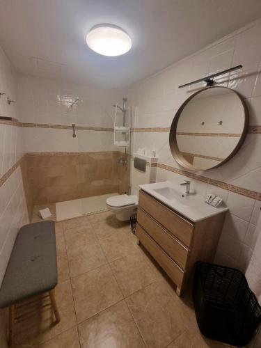 a bathroom with a sink and a toilet and a mirror at Granillo Beach Calm in Costa Calma