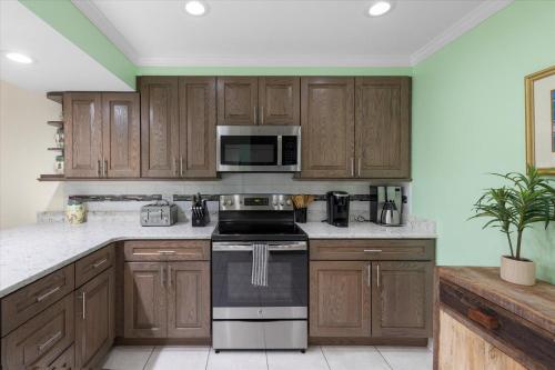 a kitchen with wooden cabinets and a stove top oven at Key West's Best in Key West
