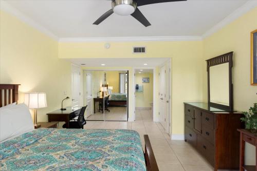 a bedroom with a bed and a dresser and a mirror at Key West's Best in Key West