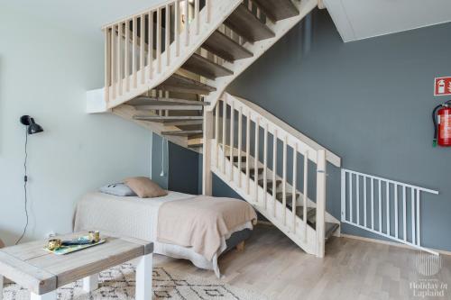 a bedroom with a bed and a staircase at Holiday in Lapland - Levin Stara A04 in Levi