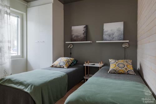 two beds sitting next to each other in a room at Holiday in Lapland - Levin Stara A04 in Levi