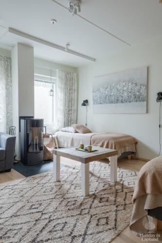 a living room with a bed and a coffee table at Holiday in Lapland - Levin Stara A04 in Levi