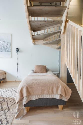 a bedroom with a bed with a blanket at Holiday in Lapland - Levin Stara A04 in Levi