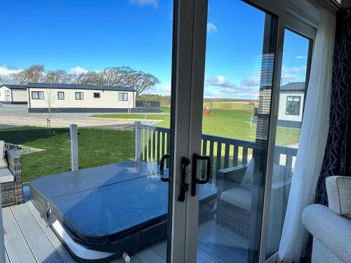 a screened porch with a view of a field at Lodge No 20 - Stewart's Resort Cameron in St. Andrews