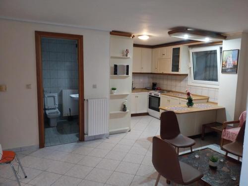 a kitchen with a table and chairs in a room at Ntolos House Old Town in Kavala
