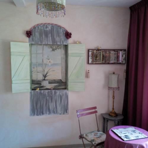 a room with a mirror and a table and a chair at La Demeure de la Vendémière in Pont-Melvez